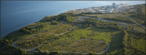 Aerial view of the Darlington New Nuclear Project site on the north shore of Lake Ontario. The adjacent, existing Darlington Nuclear Generating Station is visible in the top right corner.