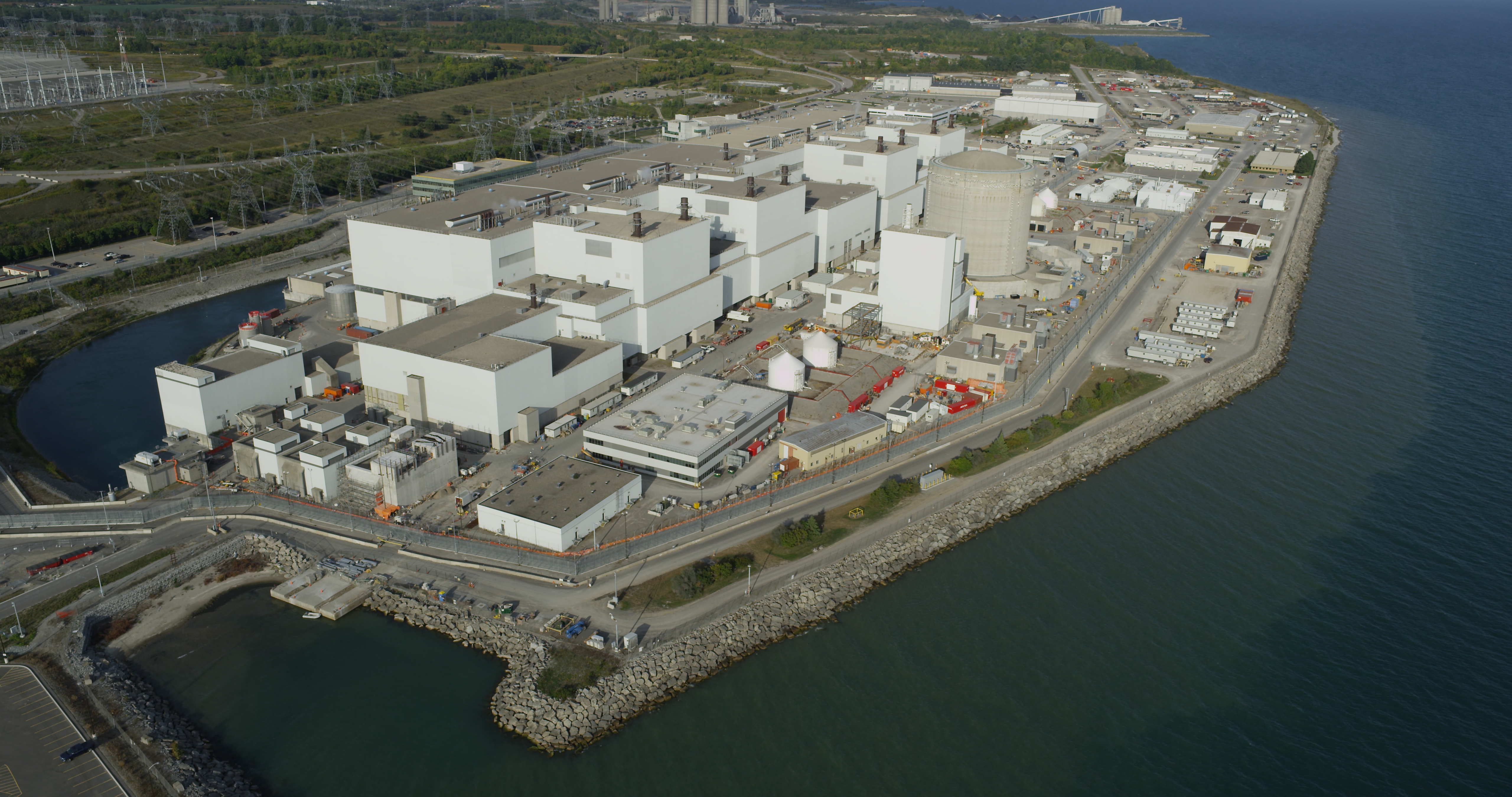 Aerial view of the Darlington facility, near the shore of a large body of water.