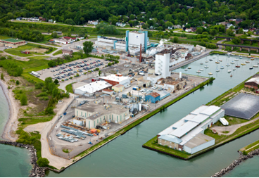 An aerial photo shows the facility, which includes multiple buildings spread across a campus.