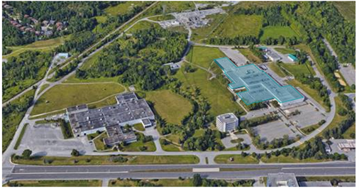 The facilityâ€™s location is highlighted in an aerial photo. It is surrounded by fields and green space.