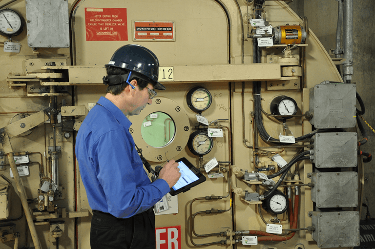 A CNSC site staff member inspects the airlock at the Bruce Nuclear Generating Station. 