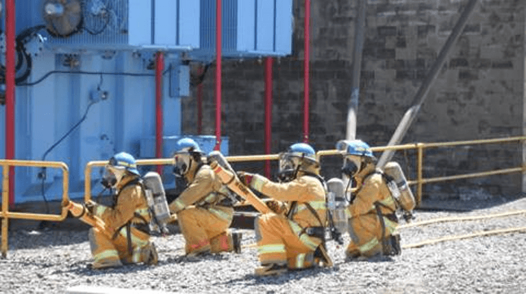 A photograph showing workers at fire protection training at the Point Lepreau Nuclear Generating Station