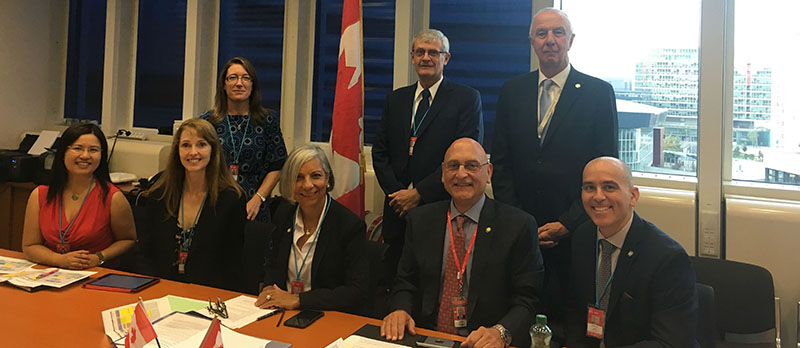 Members of CNSC staff and management posing for a picture, with CNSC president Rumina Velshi in the middle. They represent the CNSCâ€™s delegation to the IAEAâ€™s 62nd General Conference in September 2018.