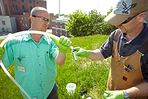 Two workers conducting groundwater sampling at Chalk River Laboratories, Ontario