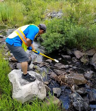 Image d’un employé de la CCSN prélevant des échantillons d’eau à Elliot Lake