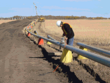 Photograph of a pipeline inspection using industrial radiography equipment.