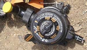 An oxygen regulator from an aircraft, with radium-painted numerals and lettering.