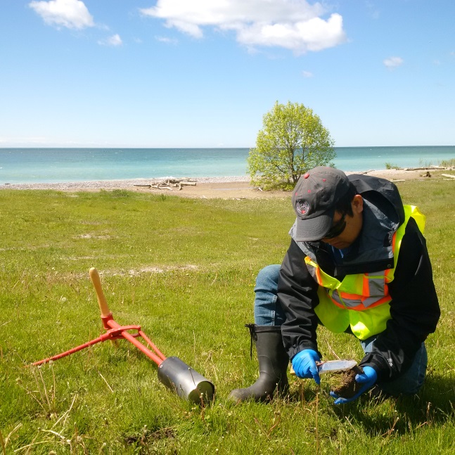 CNSC staff taking a soil sample in the vicinity of the Port Hope Conversion Facility, 2017