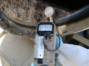 Survey meter detecting NORM in the sludge of a contaminated vac truck