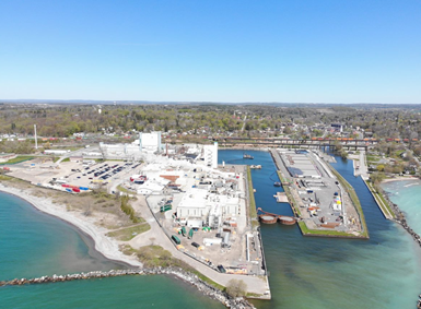 An aerial photo shows the facility, which includes multiple buildings spread across a campus.